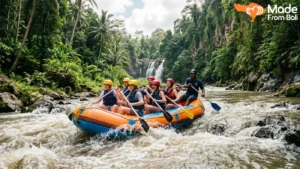 Tourists enjoying Bali rafting adventure on a jungle river with waterfalls and fast-moving water.