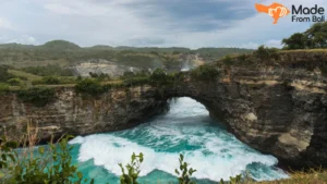Broken Beach cliffs and natural sea arch during an East Nusa Penida tour in Bali.