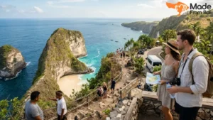 Tourists enjoying Kelingking Beach viewpoint during a Nusa Penida tour with cliffs and ocean scenery.