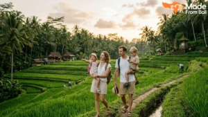Family with young children walking through Bali rice terraces, a popular outdoor activity for kids.