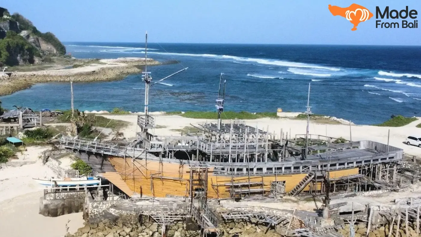 Large wooden ship structure near Melasti Beach, with ocean views and coastal scenery.