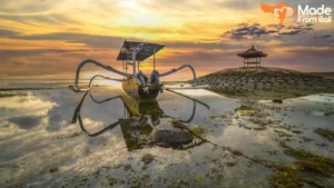 Traditional fishing boat at Sanur sunrise, a popular coastal view for first-time visitors.