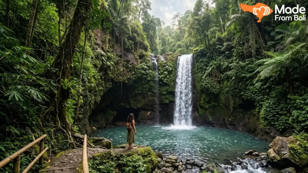Traveler standing beside a jungle waterfall in Ubud while exploring natural attractions.