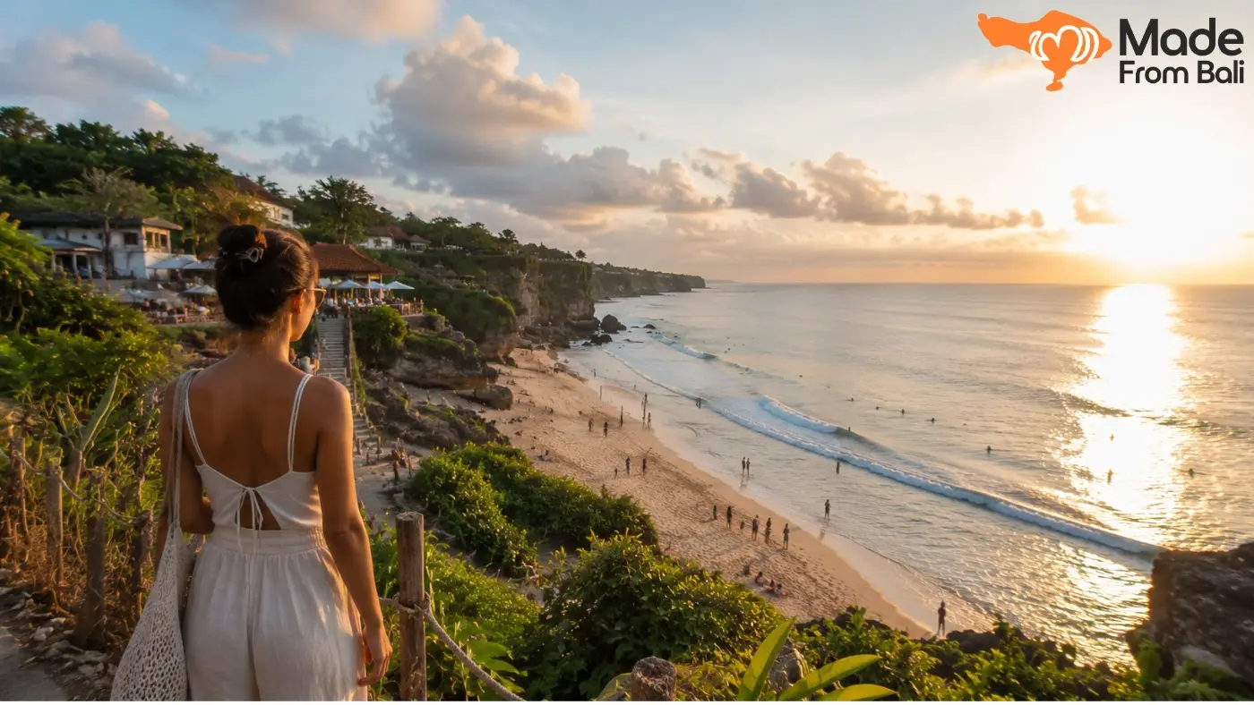A traveler overlooks a busy Bali beach at sunset, showing the dry-season atmosphere in August.