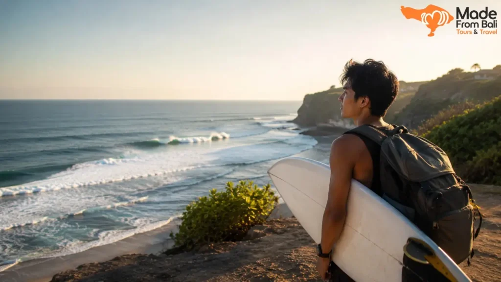 Surfer holding a surfboard overlooks Bali waves, showing different surf spots for beginners and experienced surfers.