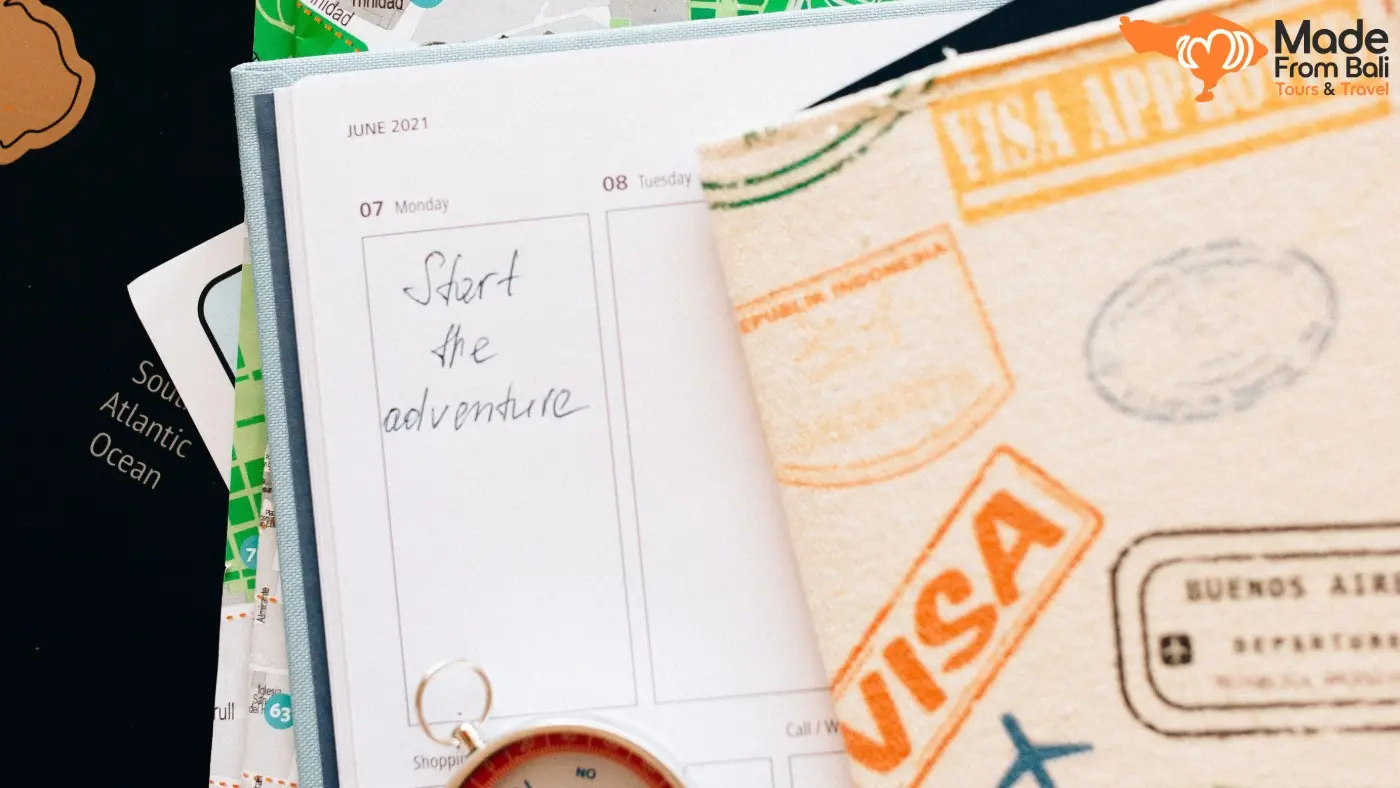 Travel documents, passport, map, and planner showing the preparation needed to meet Bali visa requirements.