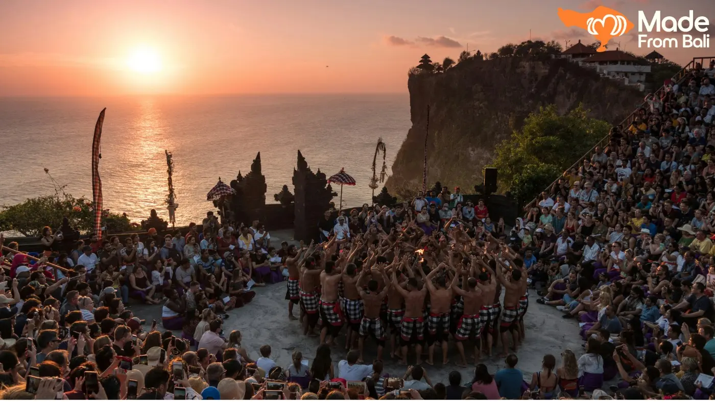 Visitors watch a Kecak dance performance at Uluwatu Temple as the sun sets over the ocean.